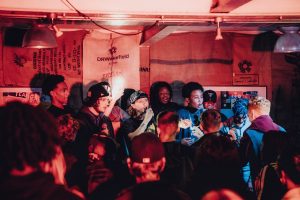 A photo of young people from LAB 7 on stage singing.