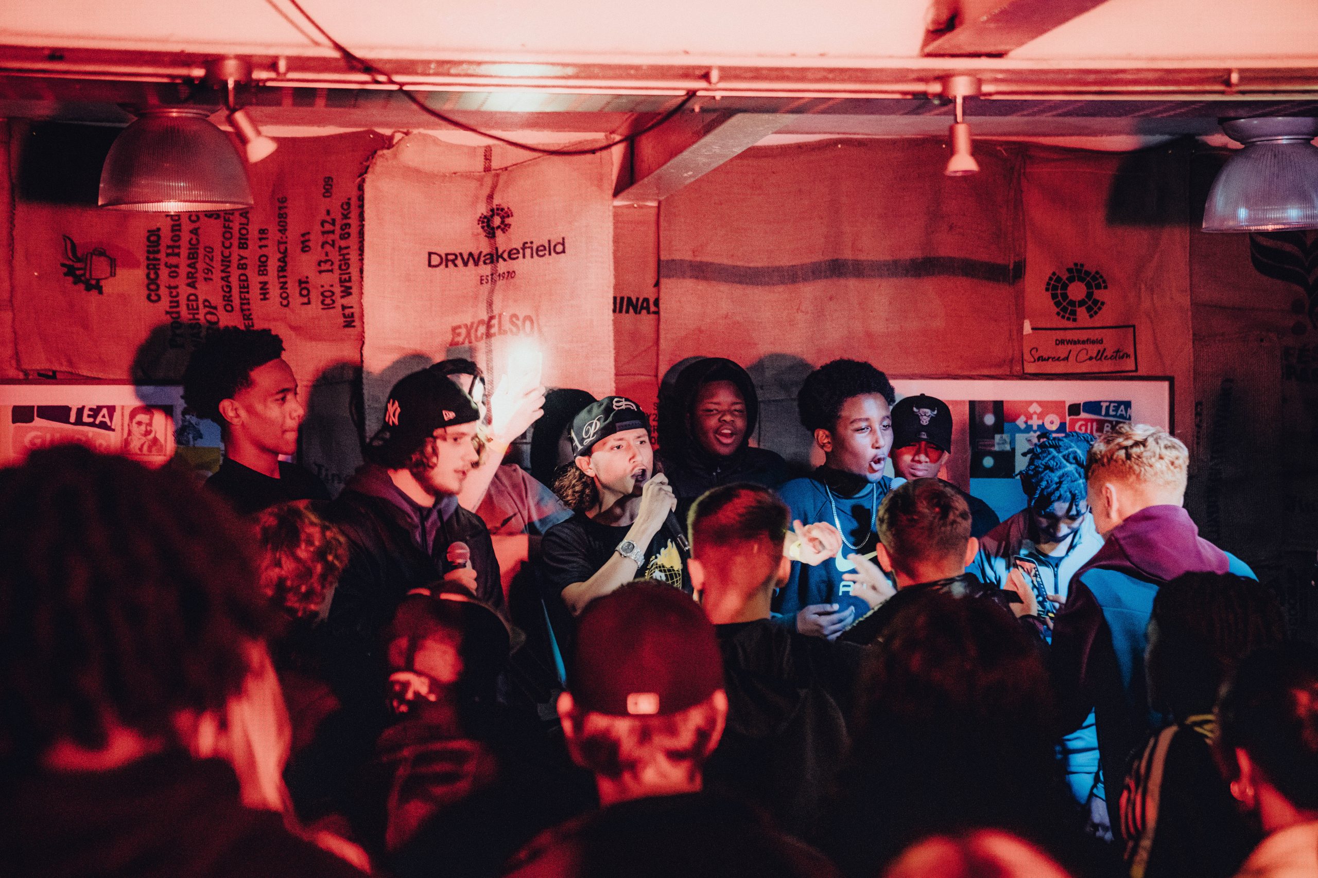 A photo of young people from LAB 7 on stage singing.