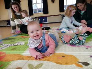 A baby, young children, and parents enjoy activities at Tregaron Family Centre.